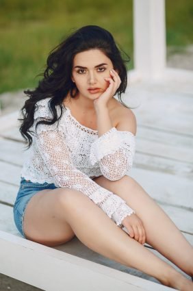 beautiful long-haired brunette in summer park